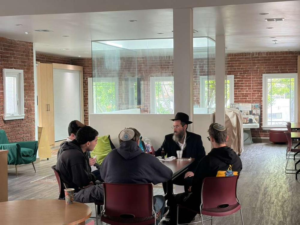 Rabbi with students at table